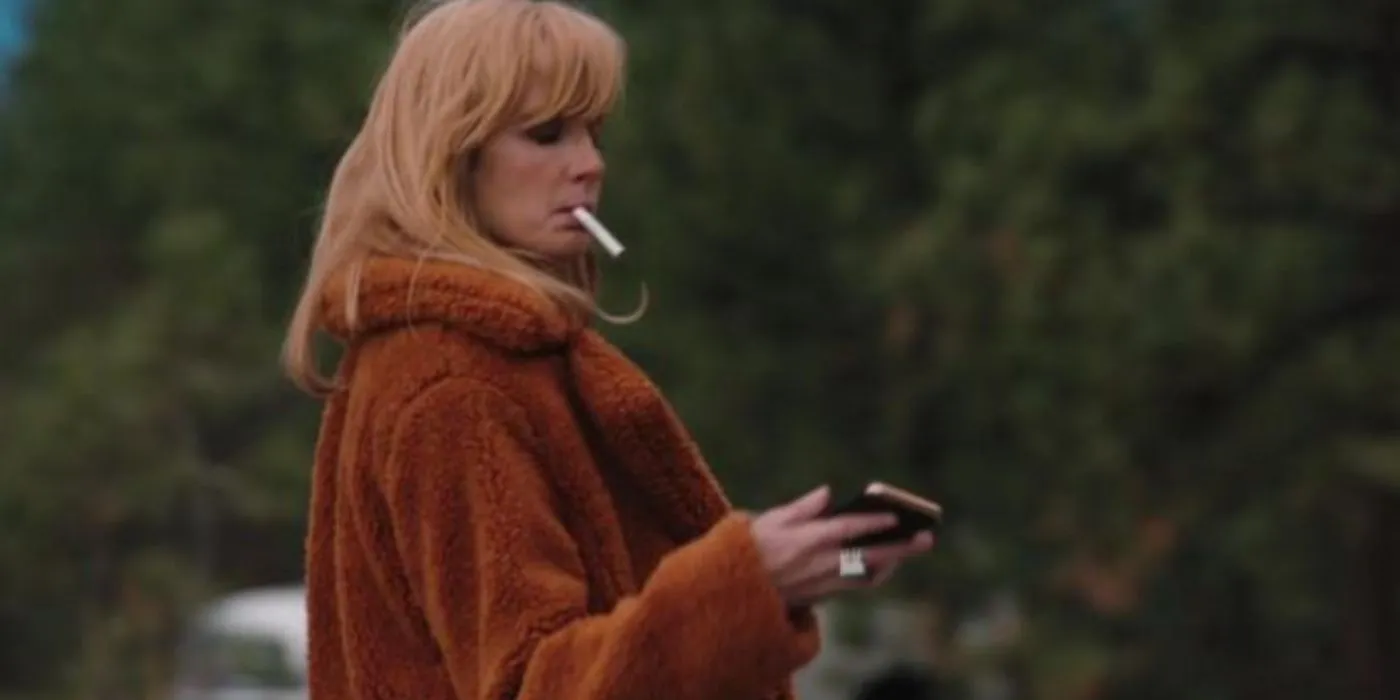 Yellowstone Beth in red coat lighting a cigarette Yellowstone Beth in red coat lighting a cigarette