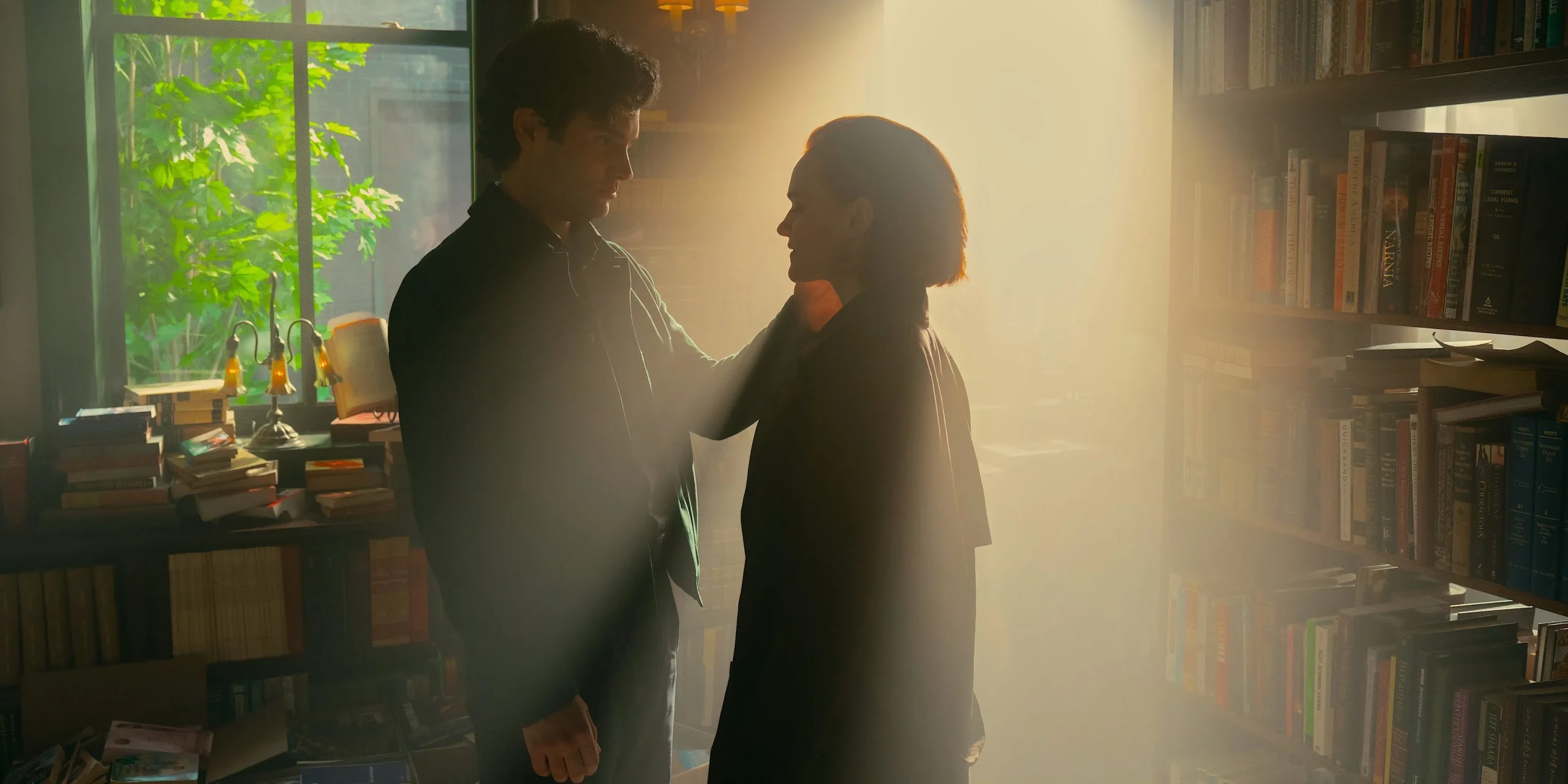 Joe cupping Bronte's face in a sunlit apartment in You season 5 Joe cupping Bronte's face in a sunlit apartment in You season 5